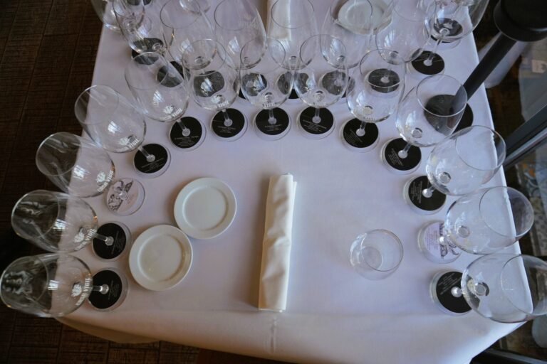 able set up at Casa Vigil restaurant with 14 wine glasses, representing the tasting experience