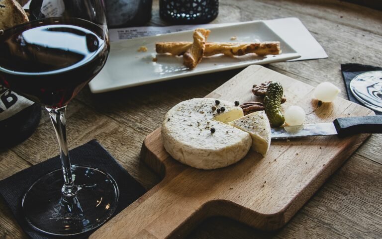 Glass of red wine paired with cheese and breadsticks - Perfect wine and food pairing