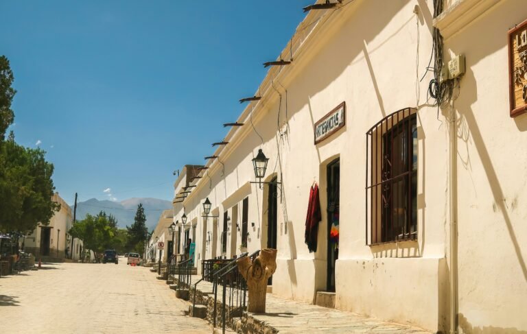 Charming scene of traditional white houses against the backdrop of Cachi's serene landscape, Argentina.