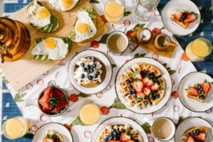 Immerse yourself in the inviting ambiance of a beautifully arranged brunch setup featuring an array of delectable dishes, perfect for a leisurely weekend morning.