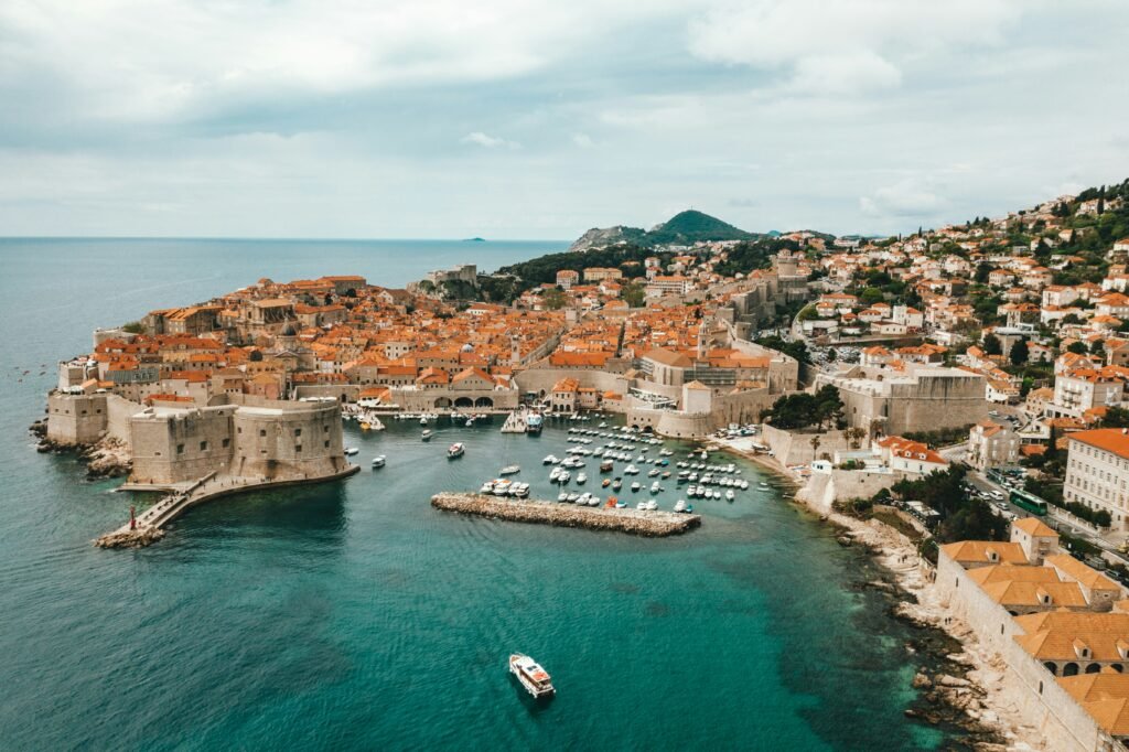 Drone view captures the breathtaking coastal cityscape of Split in Dubrovnik, Croatia, with its striking blend of ancient architecture and azure seas