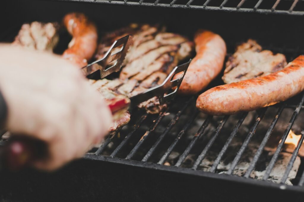 Beef and sausage sizzling on a barbecue grill, perfectly paired with a robust Rose wine