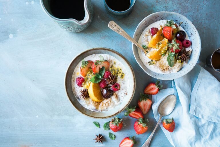 A healthy snack plate featuring a variety of fresh fruits and a serving of Greek yogurt.