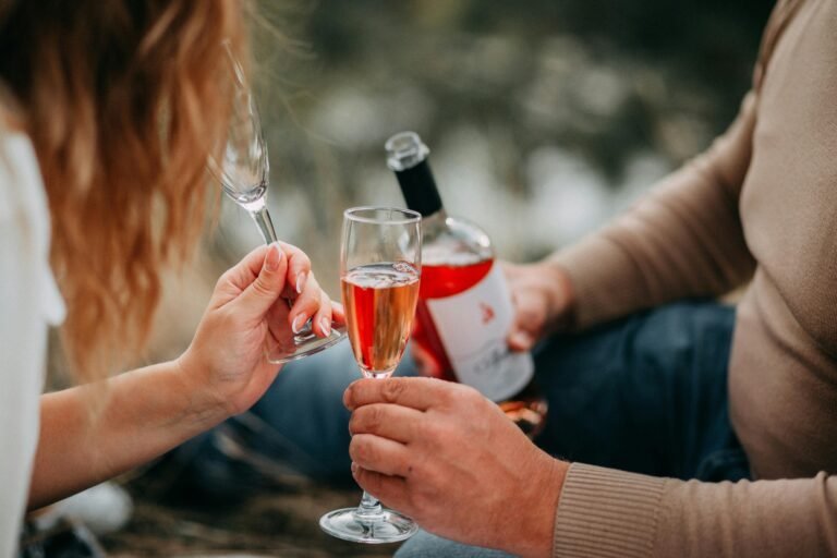 A group of friends toasting with glasses of wine to celebrate the end of their work day.