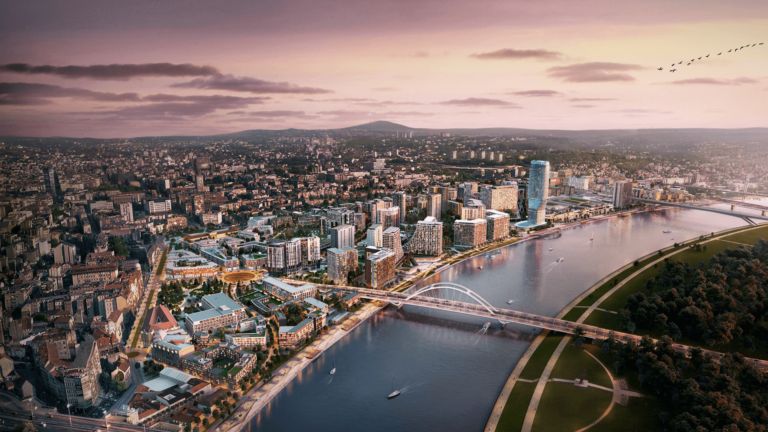 Aerial view of the Belgrade Waterfront development with modern buildings, bridges, and the Sava River at sunset