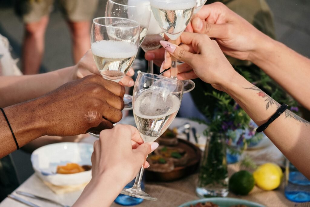 A diverse group of friends toasting with glasses of white wine at a wine tasting event.