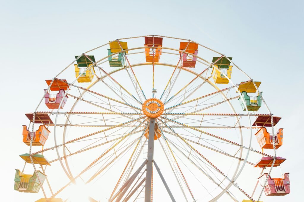 Vibrant and colorful Ferris wheel spinning at a summer fair in Chicago, United States, against a bright blue sky.