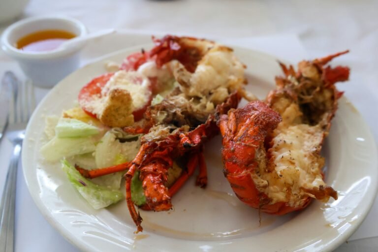 Delicious buttery grilled lobster tail served on a plate, perfectly cooked and garnished for a gourmet seafood experience.