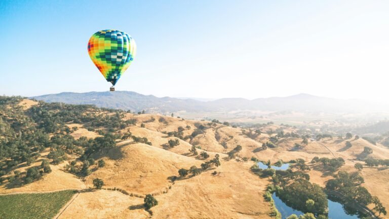 A large globe floating above the sunny and picturesque Napa Valley, showcasing the region's lush vineyards and rolling hills.