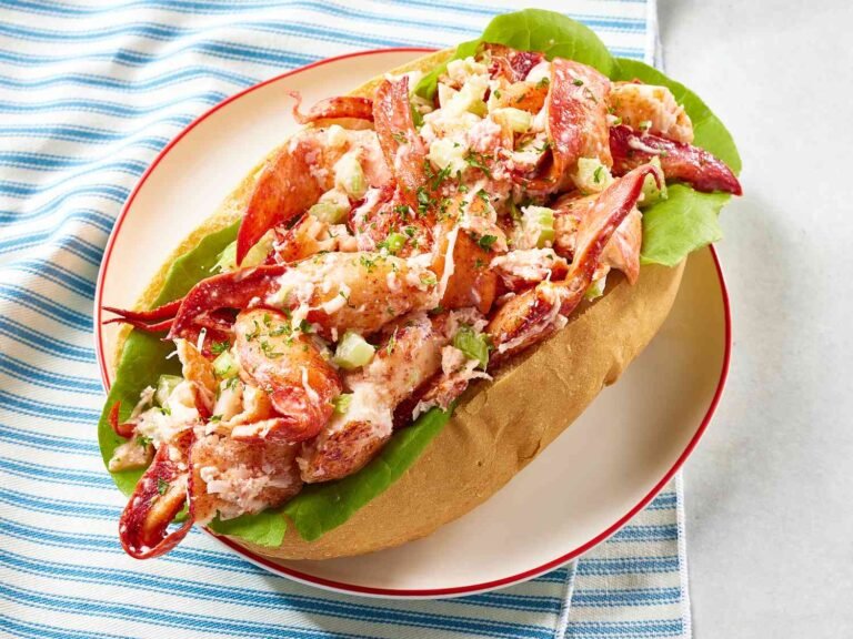 A classic lobster roll served in a toasted bun, filled with fresh lobster, celery, and lettuce.