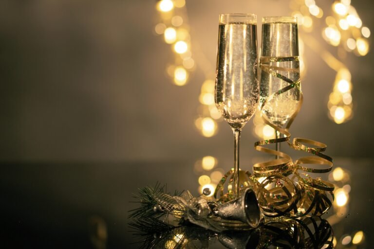 Two champagne flutes with golden decorations, perfect for New Year's celebration