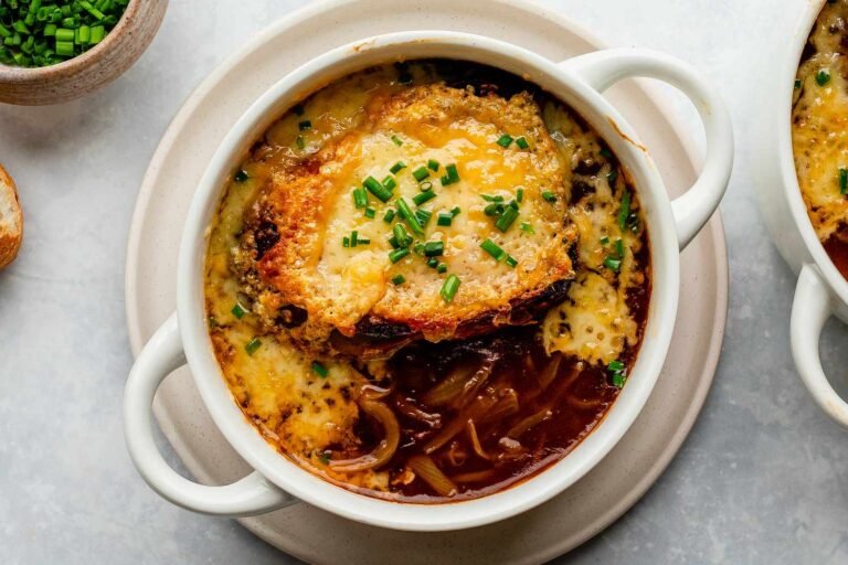 French onion soup topped with melted cheese and chives