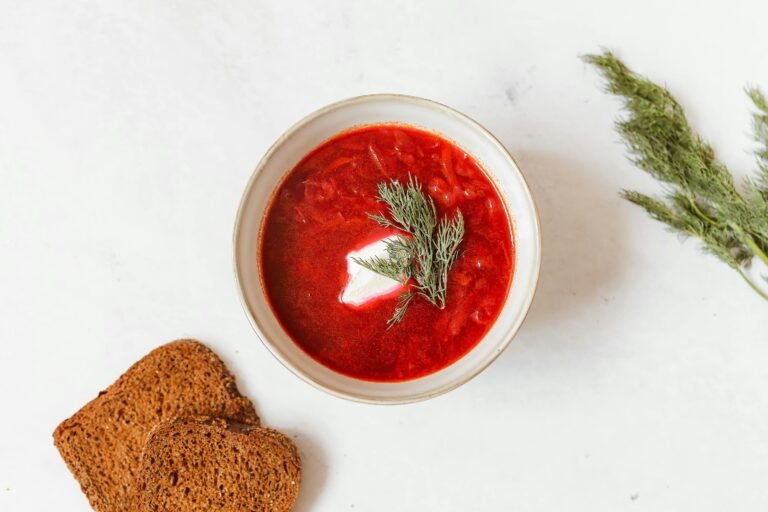 Traditional bowl of borscht garnished with dill and sour cream