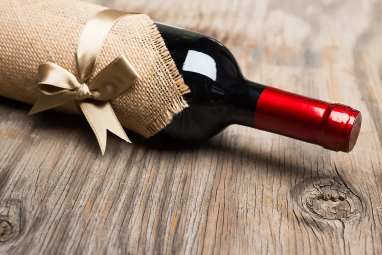 Close-up of red wine being poured into a glass, showcasing its rich colour and texture.