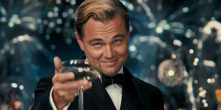 Elegant man in a tuxedo raising a glass for a toast with fireworks in the background.